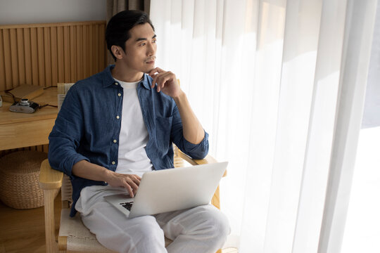 Mid adult man using laptop at home