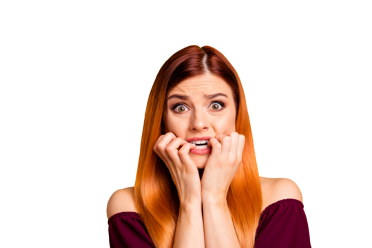 Portrait of red straight-haired attractive cute nice scared worried young girl, biting nails. Isolated over bright vivid yellow background