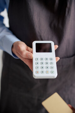 Engineer holding credit card reader at workshop