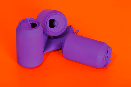 Crumpled purple cans on vibrant red background