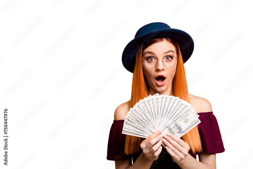 Sticker Wondered young girl in hat looks at camera with lot of money in the hands isolated on yellow background with copy space for text