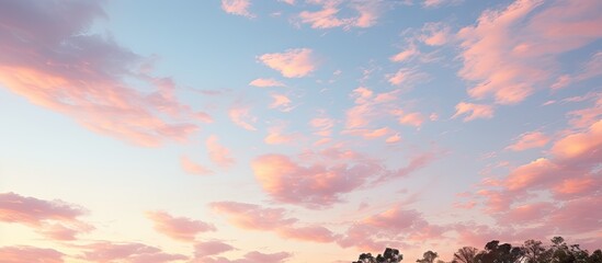 Tranquil Pink Sunset Casting a Glow on Gray and White Clouds in a Majestic Evening Sky