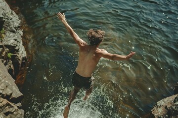 Young man jumping into water 