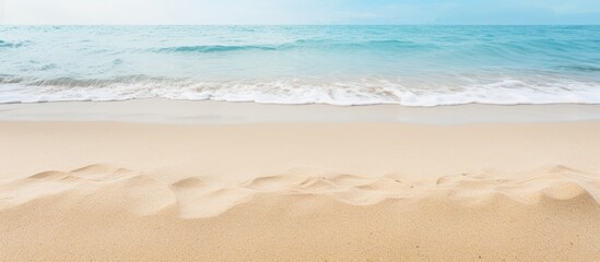 Fototapeta na wymiar Tranquil Seaside View: Sand Dunes, Ocean Waves under a Clear Blue Sky
