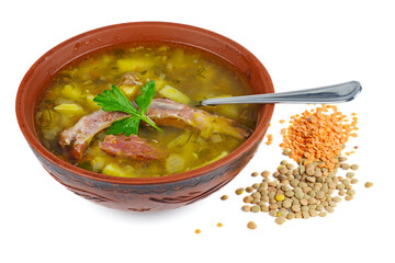 Clay bowl with lentil soup and smoked pork ribs isolated on white background.