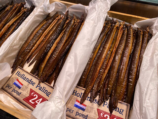Smoked eel for sale at a display at a fish smokehouse and fish shop in the Netherlands