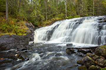 Long exposure of Koivuköngäs waterfall in Korouoma Nature Reserve near Posio, Northern Finland during autumn foliage