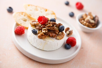 Baked camembert cheese with nuts and berries