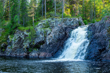 Beautiful Komulanköngäs Waterfall on Syväjoki river on a warm summer evening in Hyrynsalmi, Finland, Northern Europe