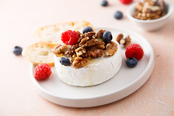 Baked camembert cheese with nuts and berries