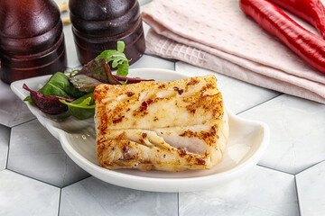 Roasted cod fish steak with salad
