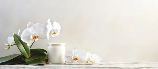 Deurstickers Elegant White Orchid Flowers Adorn a Wooden Table with Natural Beauty Products © HN Works