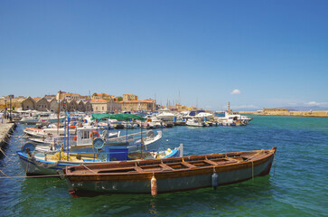 Obraz premium Picturesque scenic narrow alleys with traditional cobblestone streets and Souvenir shops in Old Town of Chania City in famous tourist attraction Crete island in Kreta Greece during Summer cruise