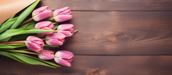 Romantic Pink Tulips Adorning a Rustic Wooden Background with Soft Shadows