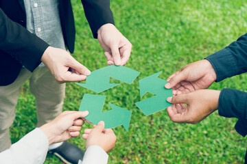 Fototapeta na wymiar People holding recycle symbol against green spring background. Earth day holiday concept.