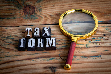 TAX FORM. Alphabet letters on wood texture background