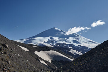 Nestled in Russia Caucasus, majestic mountain landscape captivates with its snow covered peaks, serene glaciers and rugged rock formations