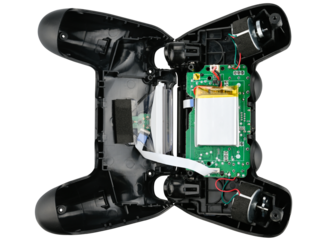 Black game controller disassembled isolated on a white background. Top view.