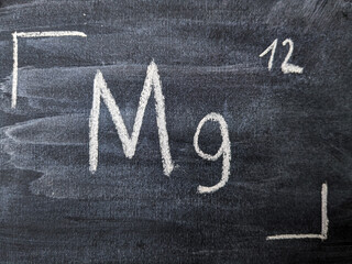The chemical element is magnesium with a serial number from the periodic table. Chalk drawing.