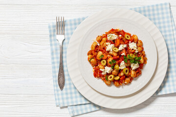 greek giant baked beans with feta, olives on plate