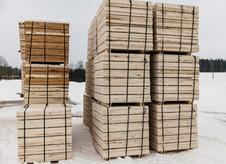 wooden plank bundles outside in winter