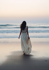 Fototapeta na wymiar Serene Beach Walk at Sunset by a Young Woman in White. Generative AI