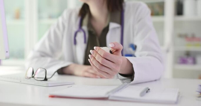 Doctor hand squeezing antistress ball at workplace in clinic closeup 4k movie slow motion. Stress resistance of medical personnel concept