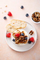 Baked camembert cheese with nuts and berries