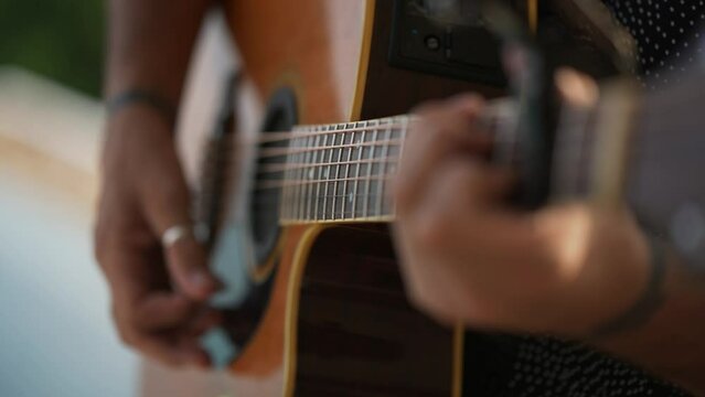 Man practicing guitar motion shoot music musician classic chord acoustic free time holiday summer. 