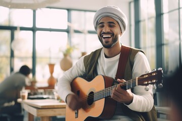 musician playing guitar with joy, feeling the music in a bright, modern space - obrazy, fototapety, plakaty