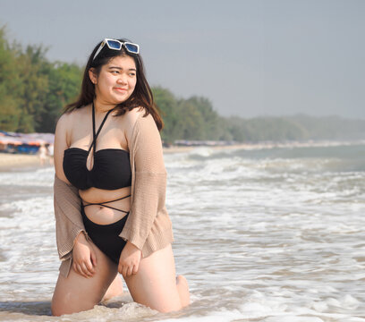 Portrait young woman asian chubby cute beautiful oneperson in bikini black sexy front viewpoint tropical sea beach white sand clean and bluesky background calm Nature ocean Beautiful wave water travel