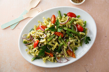 Healthy pasta salad with tomato, pesto sauce and green beans