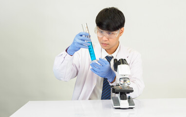 Portrait asian man student scientist Wearing a doctor gown in the lab looking hand at chemist....