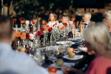 Red flower arrangements in vases, colorful decor, autumn flowers. On the festive table in the...