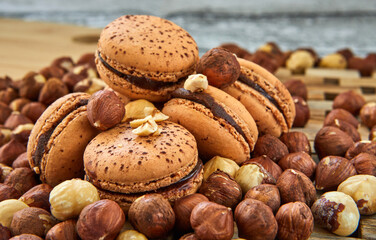 Delicious hazelnut flavored macarons on a vintage gray wooden background on a wooden stand