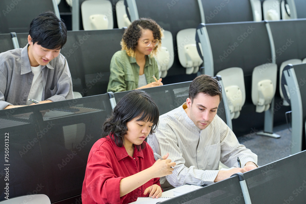Aufkleber multinational group of students taking a lecture in the auditorium