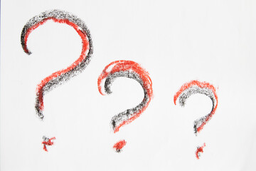 Hand-drawn question mark, boldly marked in black on a white sheet of paper, symbolizing the concept of questioning, uncertainty, and the search for information