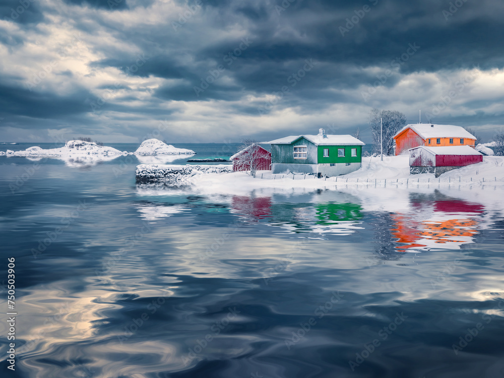 Wall mural Colorful wooden houses on Lofoten Islands reflected in the calm waters of Vestfjorden fjord, Norway. Dramatic winter scene of Justad fishing village on Vestvagoy island. Traveling concept background.