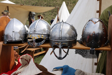 Medieval weapons, helmets in knight camp at the festival of historical reconstruction