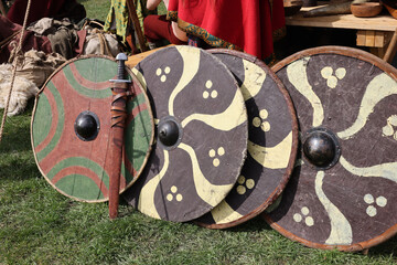 Medieval weapons, shields in knight camp at the festival of historical reconstruction