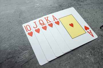 Hearts royal flush poker combination on grey background