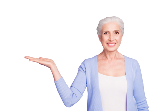 Grey haired old nice beautiful smiling woman holding product object, copy blank empty space. Isolated over violet purple background