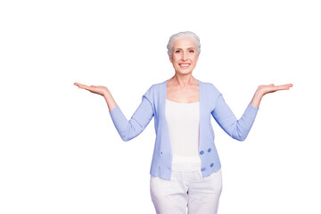 Beautiful nice cheerful smiling gray-haired old lady wearing casual, showing two options with palms. Isolated over pastel violet purple background