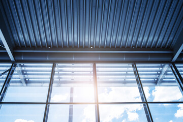 Metal construction of airport roof and windows. Sunlight through the window glass. Industrial...