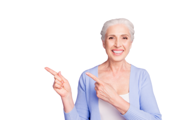 Beautiful nice cheerful smiling gray-haired old lady wearing casual, showing pointing way with two fingers. Copy space. Isolated over pastel violet purple background