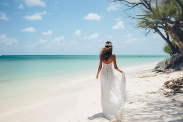 Fototapeta na wymiar a girl walking along a paradisiacal Caribbean beach dressed in a white wedding dress