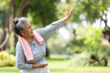 asian senior woman workout and practice tai chi in the park