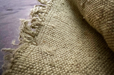 Burlap fabric with raw edge close up. Natural 100% hemp fabric, organic. Hessian