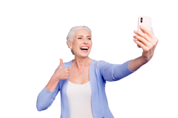 Grey haired old happy excited funny funky woman wearing casual, taking self picture, showing thumb up, opened mouth. Isolated over violet purple background
