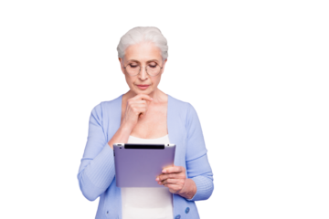 Grey haired old serious business woman wearing glasses, reading browsing using tablet, copy space. Isolated over violet purple background
